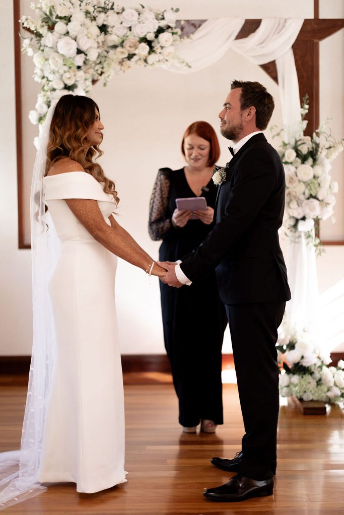 Fun Sunshine Coast wedding celebrant Sarah Dawes performing wedding ceremony with bride and groom