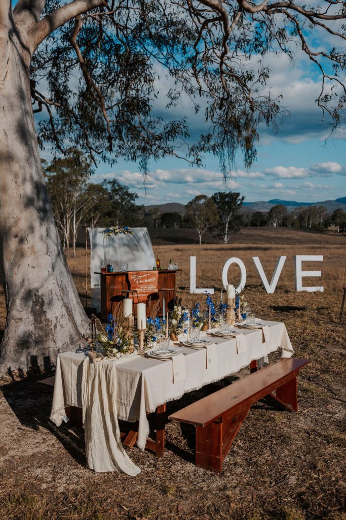 Gympie wedding venue tablescape for outdoor reception with blue and white details