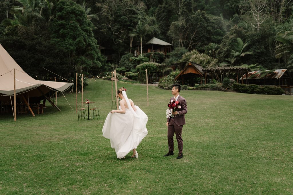 Bride and groom walking to tipi wedding reception at Montville wedding venue Secrets on the Lake