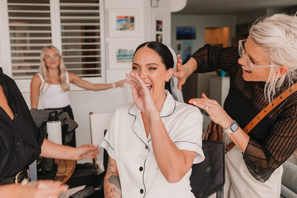 bride getting hair and makeup done on wedding day in Noosa